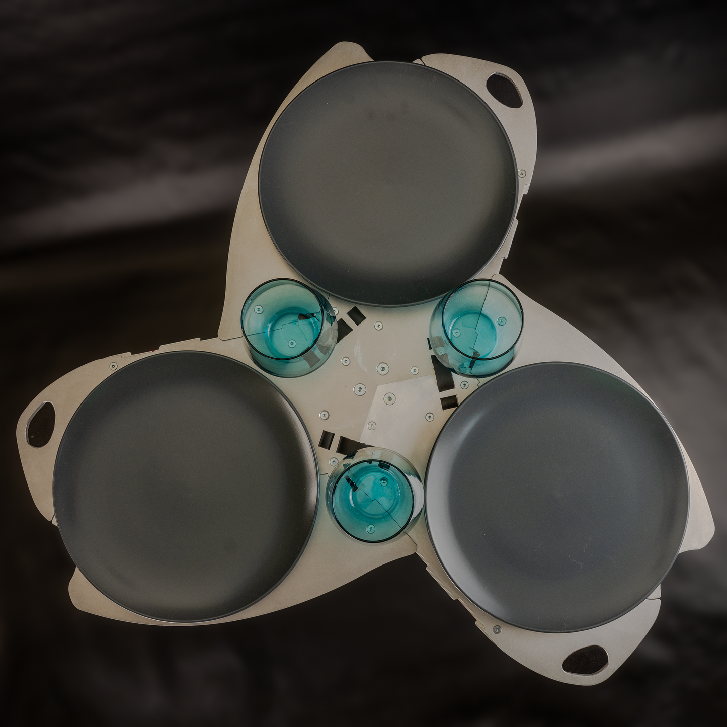 Sego side table with three dinner plates and three glasses for scale, top down view