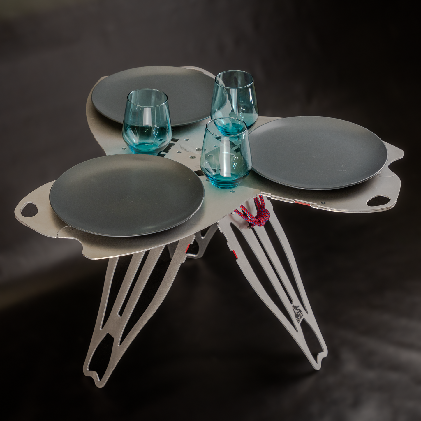 Sego side table with three glasses and three plates for scale